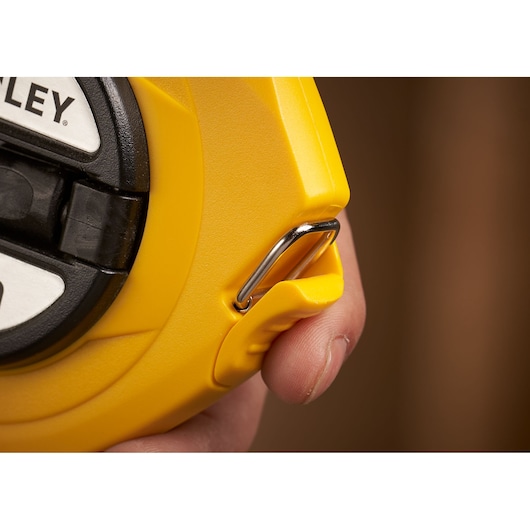 STANLEY 0-34-102 tape measure close-up showing yellow casing and metal clip.