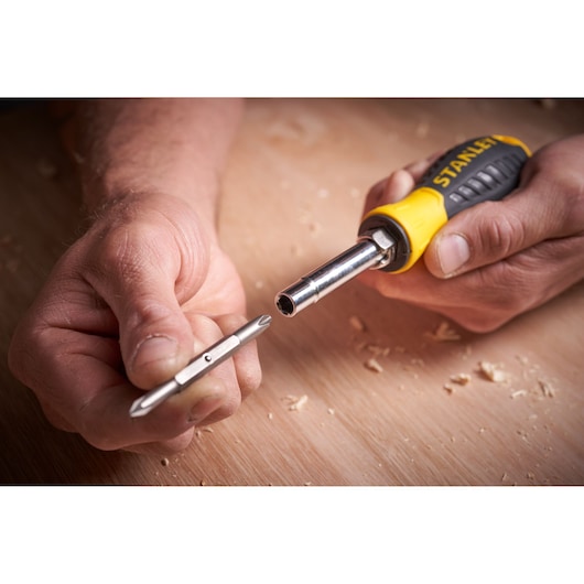 Photo of STANLEY 0-68-012 screwdriver handle and interchangeable bit on wooden surface.