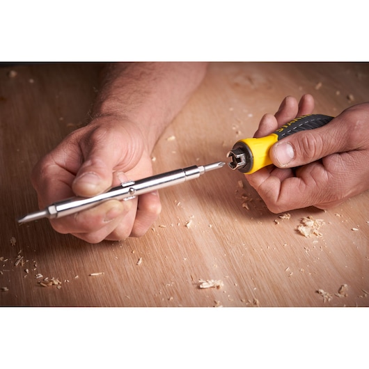 STANLEY 0-68-012 screwdriver set with yellow handle and interchangeable bit, photo of tool in use.