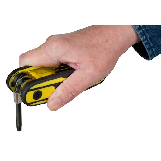 Photo of STANLEY 0-97-553 folding hex key set held in a hand, showing yellow and black handle.