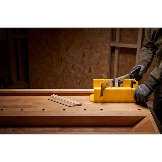 STANLEY 1-20-600 photography of yellow mitre box used for sawing wood on workbench.