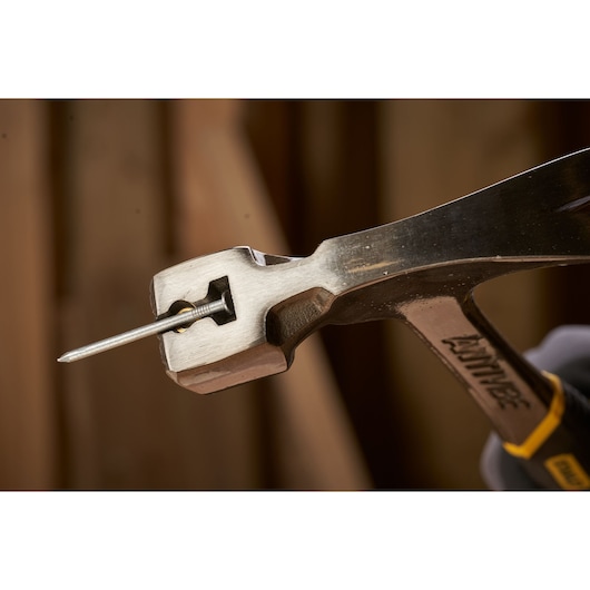 STANLEY 1-51-937 hammer head holding a nail, close-up photography of tool and mechanism.