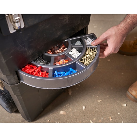 STANLEY 1-93-968 mobile toolbox with open organizer drawer showing assorted screws and wall plugs, top angle.