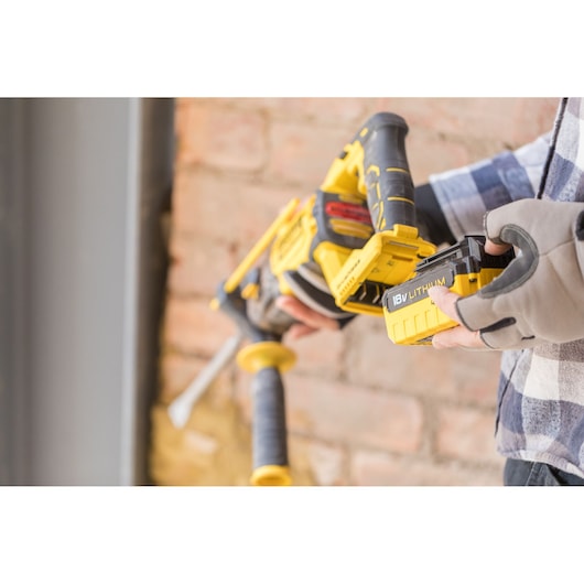 STANLEY FMCD900M2S cordless tool with 18V lithium battery being installed, close-up view.