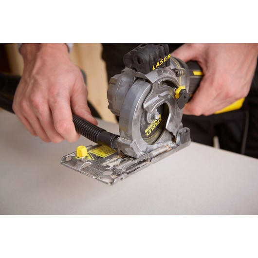Photo of STANLEY FME380K circular saw in use, close-up showing blade and handle.