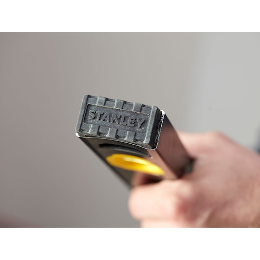 Stanley FMHT42447-1 spirit level close-up held in hand, showing branded end cap and yellow details.