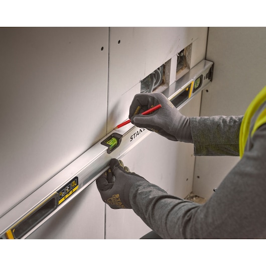 Photo of STANLEY FMHT43674-1 spirit level used to mark drywall during construction.