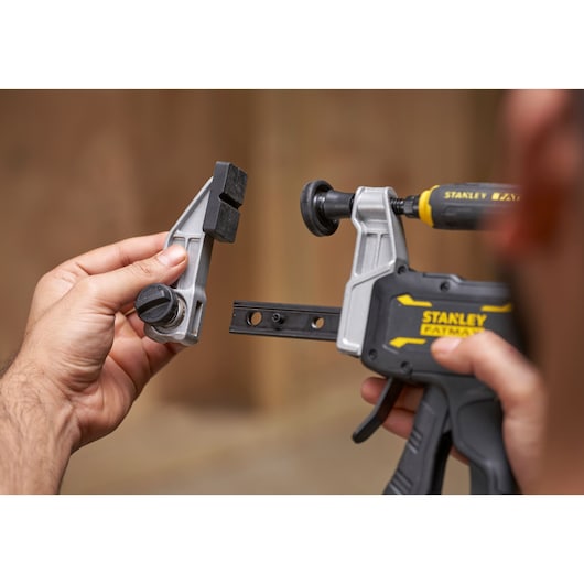 STANLEY FMHT83006-0 photography of clamp with removable jaw, close-up in hand, black and silver.