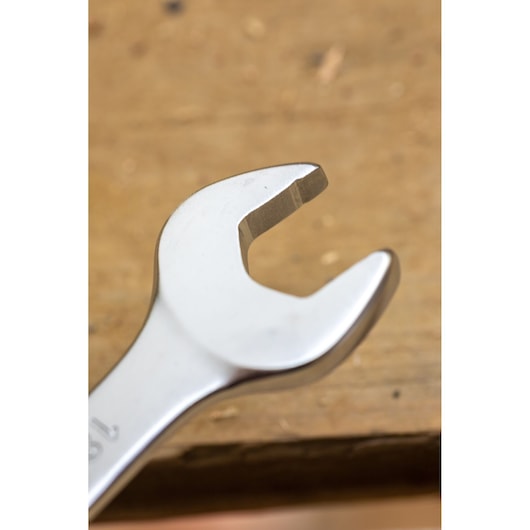 STANLEY FMMT13036-0 open-end wrench close-up, silver finish, photography on wooden surface.