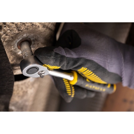 STANLEY FMMT17207-0 ratchet wrench being used on a bolt by a gloved hand, close-up view.