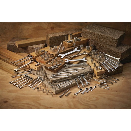 STANLEY FMMT17207-0 photography of assorted wrenches and sockets arranged on wood and concrete blocks.