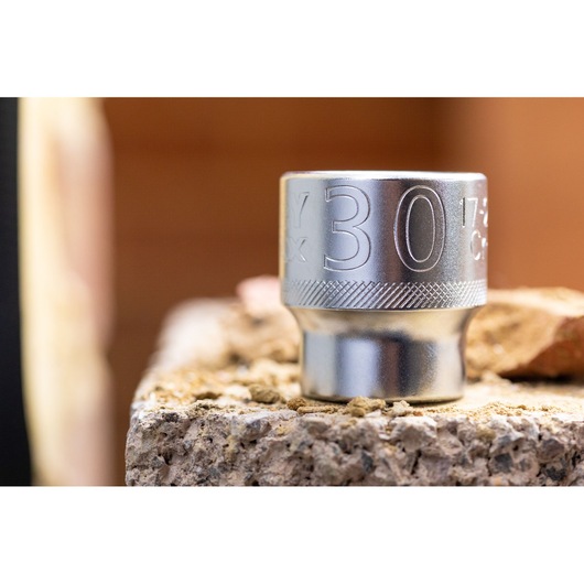 STANLEY FMMT17245-0 socket, silver, 30mm, close-up angle, photography on rough surface.