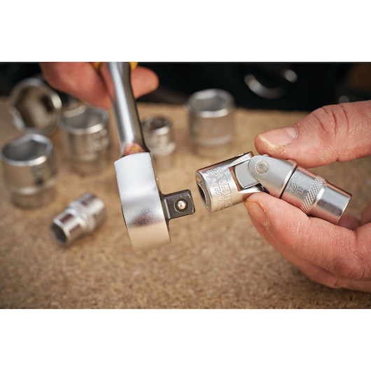 STANLEY FMMT18011-0 socket and universal joint photography, close-up, chrome finish, hand holding tool.