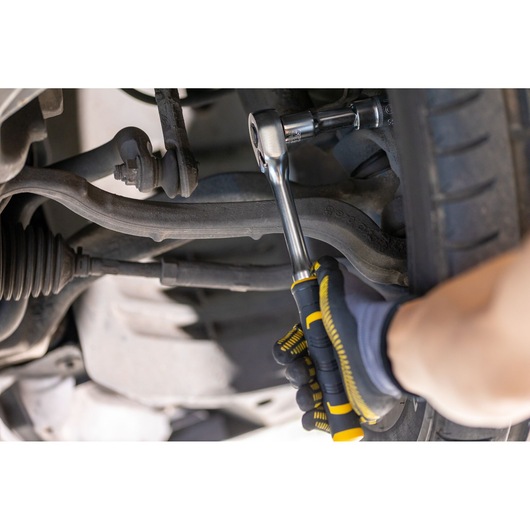 STANLEY FMMT82677-0 ratchet wrench in use tightening a bolt on a car suspension, close-up photography.
