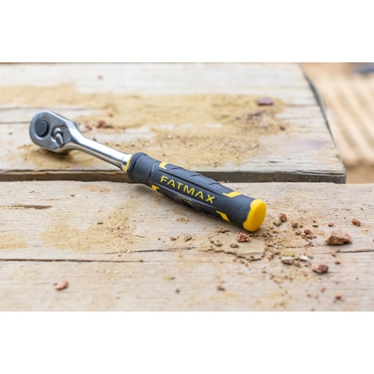 STANLEY FMMT82677-0 ratchet with black and yellow FATMAX handle on wooden workbench.