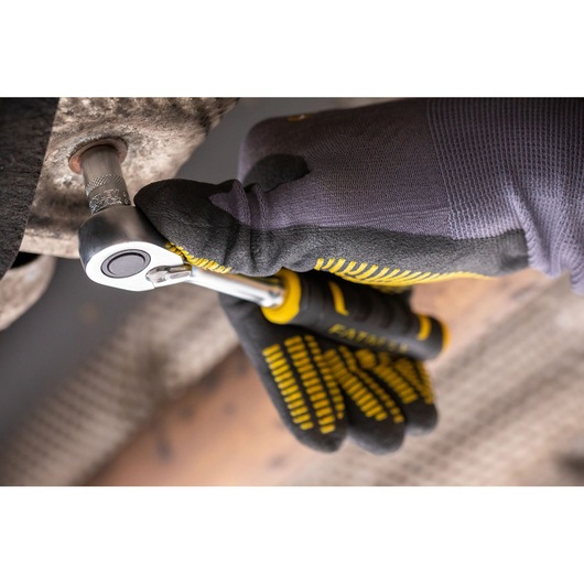STANLEY FMMT82683-0 ratchet wrench in use, gloved hand turning metal bolt, close up angle.