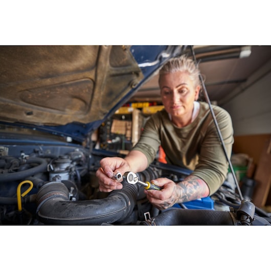 STANLEY FATMAX FMMT82827-1 ratchet socket in use for auto repair, shown with a mechanic working under car hood.