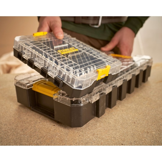 STANLEY FMMT98104-0 black and clear plastic organizer box with yellow latches, shown in use.