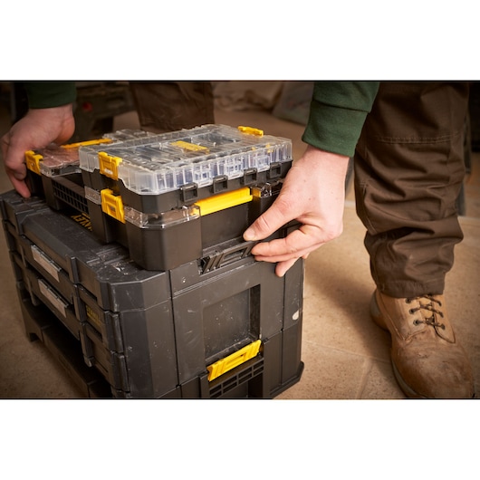 STANLEY FMMT98104-0 stackable black and yellow tool organizer, close-up in use, angled view.