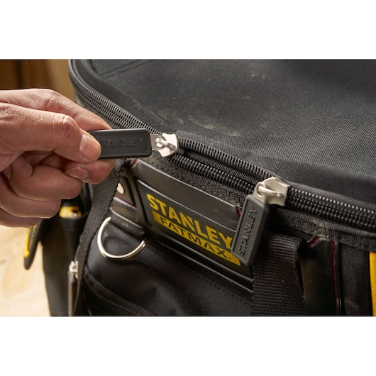 Photo of STANLEY FMST1-70749 tool bag zipper with hand opening black fabric bag.