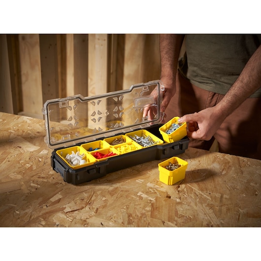 STANLEY FMST1-75781 organizer box with yellow removable bins for hardware, angled view on workbench.