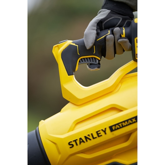 STANLEY SFMCBL7B blower handle close-up, yellow and black, FATMAX logo visible, gloved hand holding.