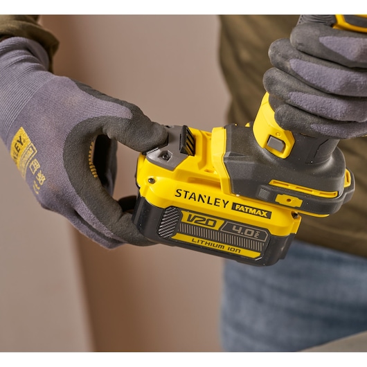 Photography of STANLEY SFMCE200B cordless tool with V20 4.0Ah lithium-ion battery, close-up side view.