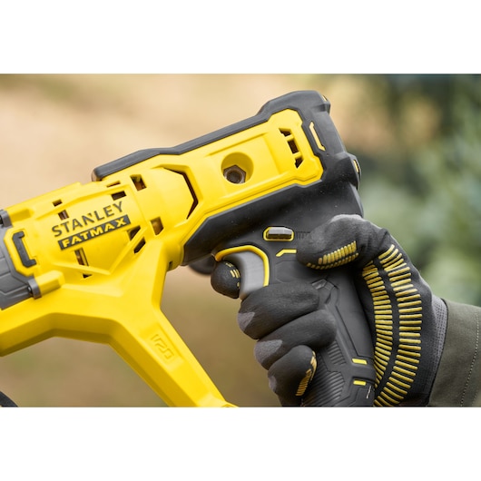 STANLEY SFMCGA75M1 FATMAX yellow and black power tool, close-up of handle, photography.