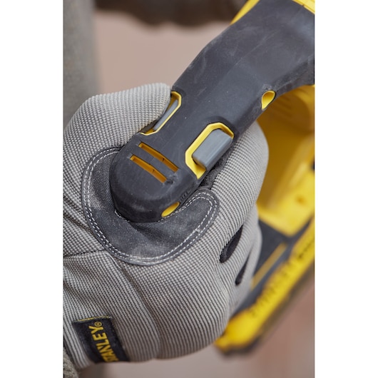 STANLEY SFMCH900B power tool handle held by gloved hand, close-up photography.
