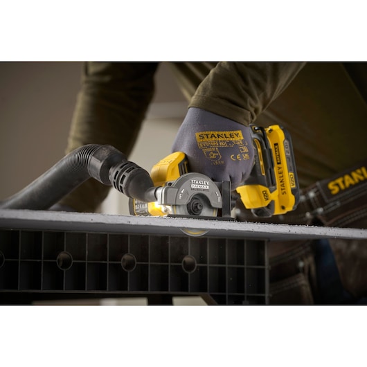 STANLEY SFMCM300D2 cordless drywall cut-out tool in use, close-up showing cutting action and dust extraction.