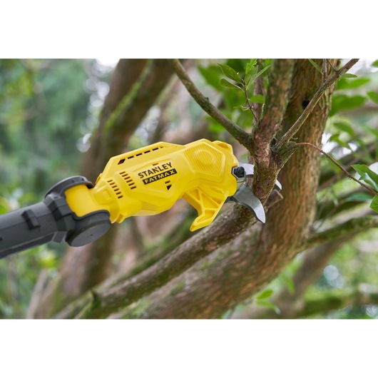 Stanley SFMCPP632D1 cordless pruning shears cutting tree branch outdoors, close-up view.