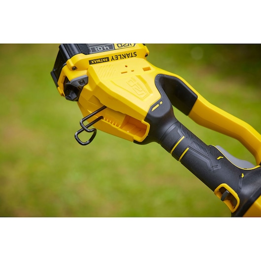 STANLEY SFMCPS620B grass trimmer handle close-up showing yellow and black ergonomic grip and belt hook.