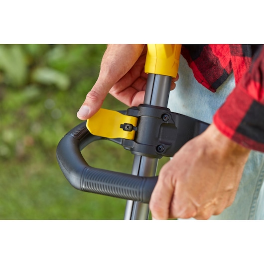 STANLEY SFMCSTB933B close-up of adjustable handle grip on outdoor power tool, photography from side angle.