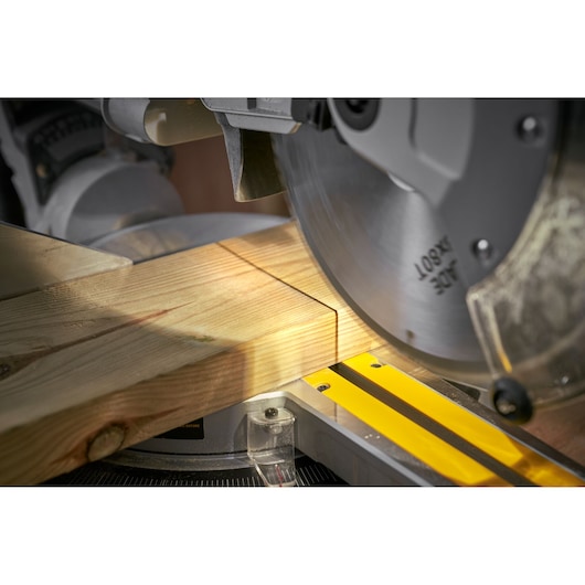 STANLEY SM1800 miter saw cutting wood plank, close-up angle, photography product category.