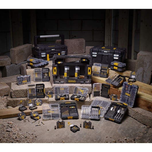 STANLEY STA88558 drill and bit kit assortment with hard cases, displayed on construction site blocks, front angle.