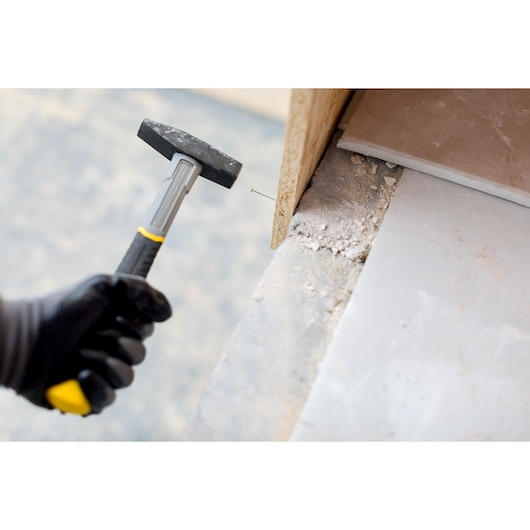 Photo of STANLEY STHT0-51907 club hammer with black handle driving nail into wood.