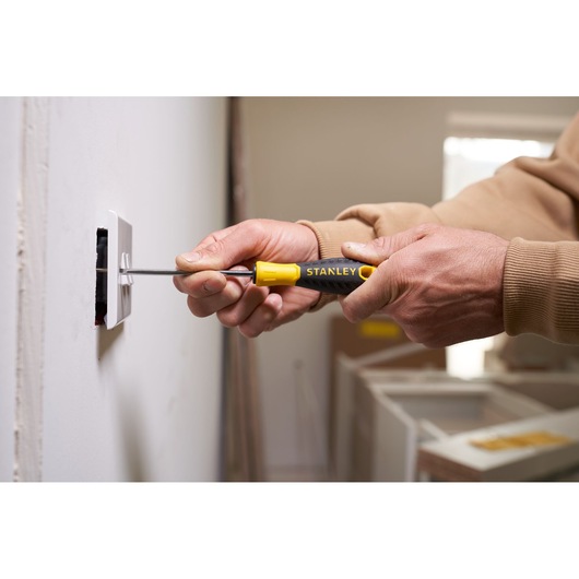 Photo of STANLEY STHT0-60358 screwdriver, yellow and black handle, used to install wall outlet.