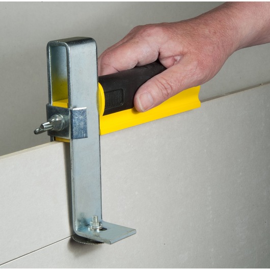 STANLEY STHT1-16069 drywall cutting tool with black and yellow handle in use.