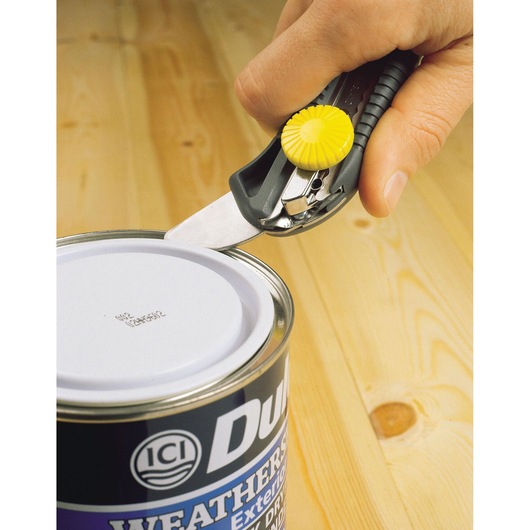 STANLEY STHT7-10220 utility knife with yellow wheel, cutting open a paint can, side angle.