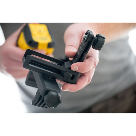 Photo of STANLEY STHT77498-1 photography accessory mount held in hand, black with adjustment knob.