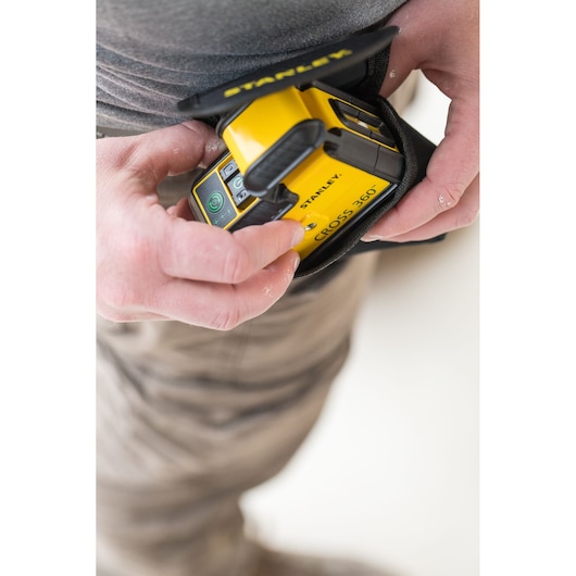 Photo of STANLEY STHT77641-1 laser level being held in a carrying case, close-up view.