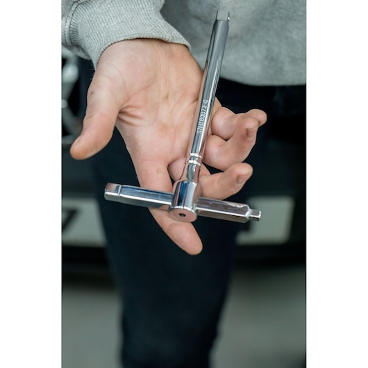 STANLEY STHT80872-0 T-handle socket wrench in chrome finish held in hand.