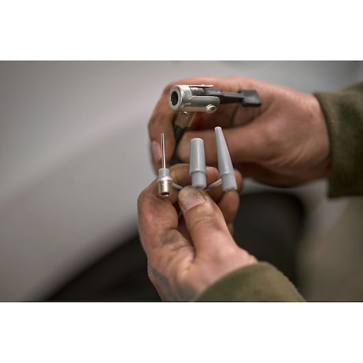 STANLEY STHT80894-1 inflation nozzle set held in hand, detailed close-up photography.