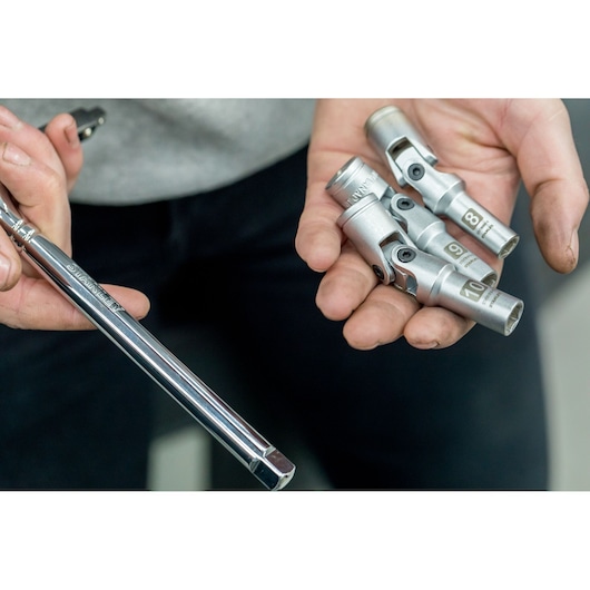 Photo of STANLEY STHT81015-0 socket set and extension bar held in a hand, close-up view.