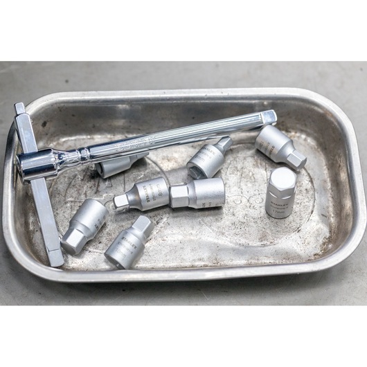 STANLEY STHT81578-0 socket wrench and hex sockets set in a metal tray, top view.
