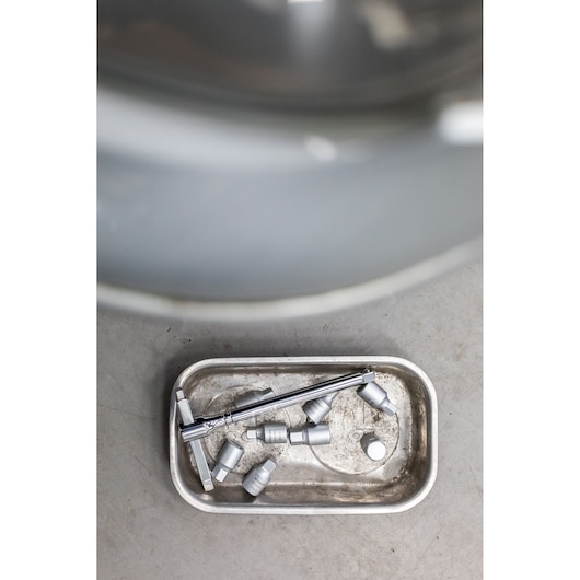 STANLEY STHT81579-0 sockets and wrench in a metal tray, top view, workshop photography.