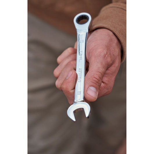 Close-up photo of STANLEY STMT82846-0 flat ratcheting wrench from 7-piece set held in hand.