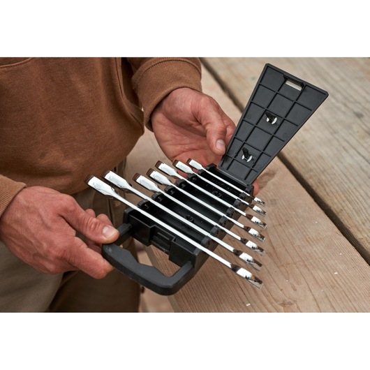 STANLEY STMT82846-0 ratcheting wrench set with 7 pieces in black plastic case, held outdoors.