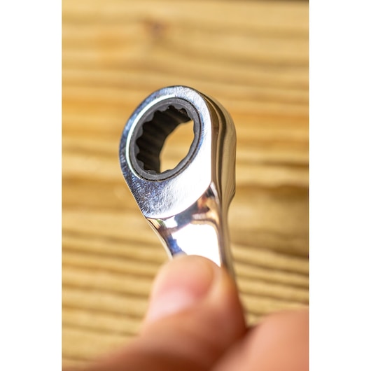 STANLEY STMT82847-0 close-up photo of chrome ratcheting wrench head held by hand.