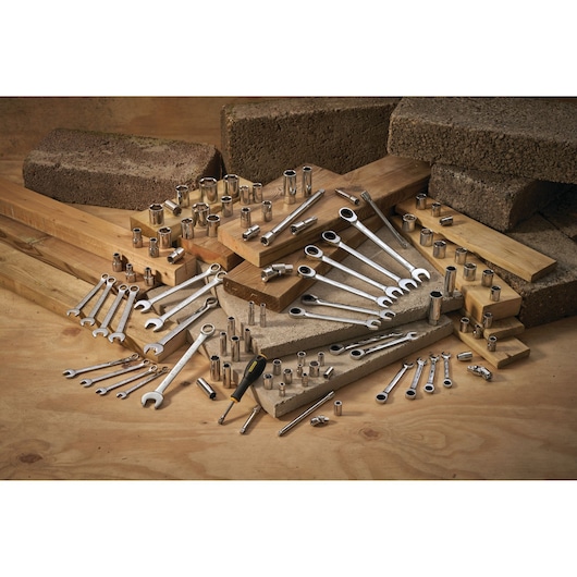 STANLEY STMT86114-0 hand tools and sockets set arranged on wood and concrete blocks.